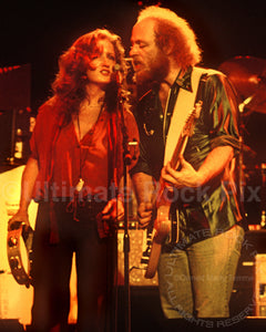 Photo of Bonnie Raitt singing with Paul Barrere of Little Feat in concert in 1978 by Marty Temme