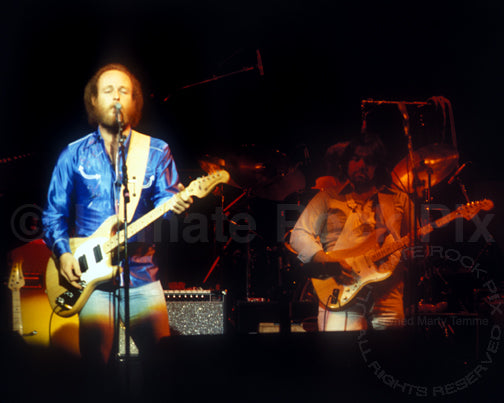 Photo of Paul Barrere and Lowell George of Little Feat in concert in 1978 by Marty Temme