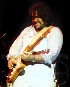 Photo of guitarist Lowell George of Little Feat playing slide on his Fender Stratocaster in concert in 1978 by Marty Temme