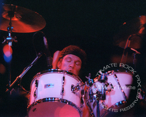 Photo of drummer Ian Wallace of David Lindley in concert in 1981 by Marty Temme
