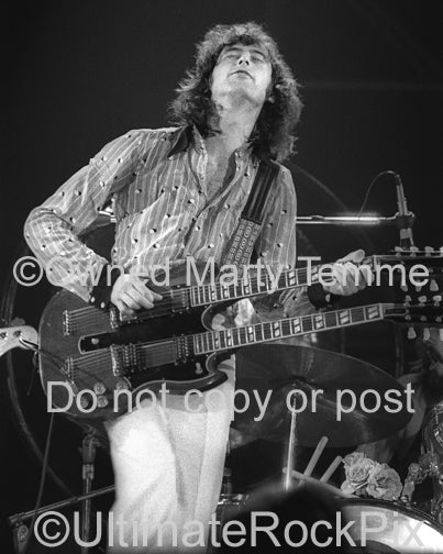 Black and white photo of Jimmy Page playing a doubleneck in 1973 by Marty Temme