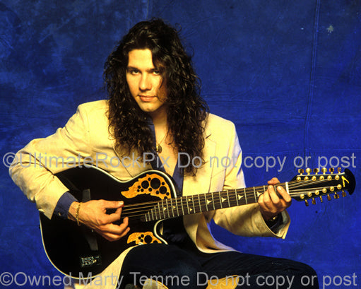 Photo of Mark Slaughter playing an Ovation acoustic guitar during a photo shoot in 1992 by Marty Temme