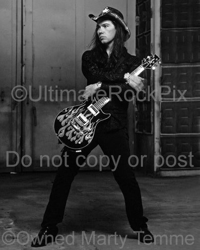 Black and white photo of Mark Slaughter holding a guitar during a photo shoot in 2003 by Marty Temme