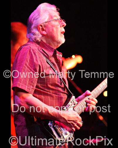 Photo of blues legend John Mayall playing guitar in concert in 2008 by Marty Temme