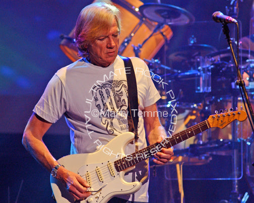 Photo of Justin Hayward of The Moody Blues playing a Stratocaster in concert by Marty Temme