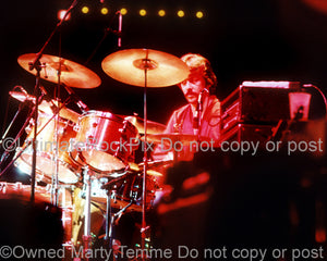 Photo of drummer Michael Botts playing with Andrew Gold in concert in 1976 by Marty Temme