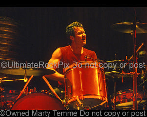 Photo of drummer Rob Hirst of Midnight Oil in concert in 2002 by Marty Temme