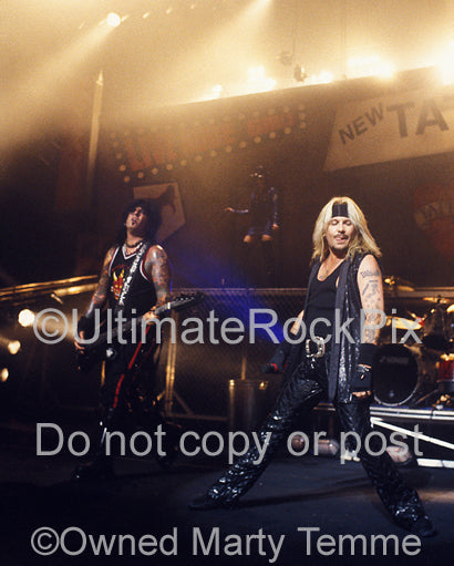Photo of Vince Neil and Nikki Sixx of Motley Crue in concert by Marty Temme