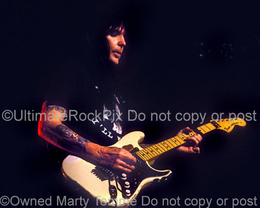 Photo of Mick Mars of Motley Crue playing a Stratocaster in concert by Marty Temme