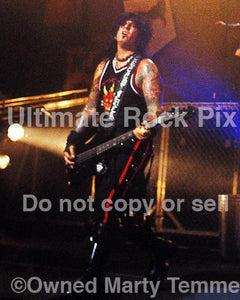 Photo of Nikki Sixx of Motley Crue in concert in 2000 by Marty Temme