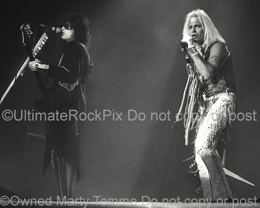 Photo of Nikki Sixx and Vince Neil of Motley Crue in concert in 1985 by Marty Temme