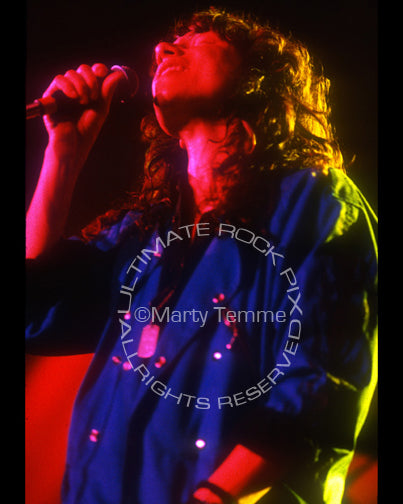 Photo of Eric Martin of Mr. Big singing in concert in 1991 by Marty Temme