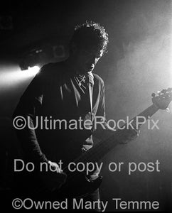Black and white photo of Jason Newsted of Metallica in concert by Marty Temme