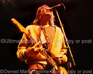 Photo of Kurt Cobain of Nirvana singing and playing guitar onstage in 1991 by Marty Temme