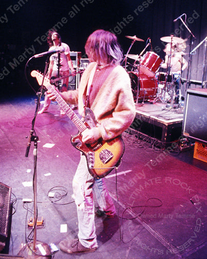 Photo of Kurt Cobain of Nirvana playing a Fender Jaguar in 1991 by Marty Temme