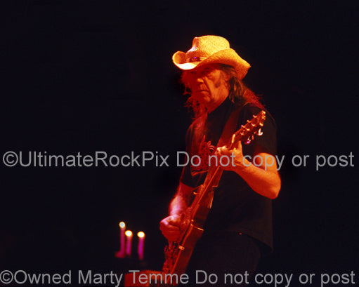Photo of Neil Young of CSNY playing a Les Paul in concert by Marty Temme