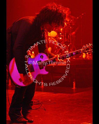 Photo of Steve Conte of New York Dolls in concert in 2008 by Marty Temme