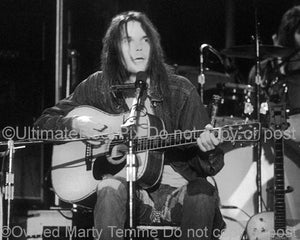 Black and White Photo of Neil Young of CSNY Performing in Concert in 1973 by Marty Temme