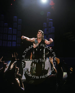 Photo of Ozzy Osbourne interacting with the crowd in concert in 1989 by Marty Temme