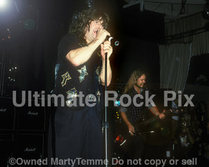 Photo of Ozzy Osbourne performing in concert in 1990 by Marty Temme