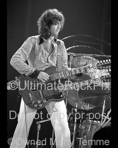 Black and white photo of Jimmy Page playing a Doubleneck SG in concert in 1973 by Marty Temme