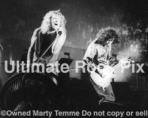 Photo of Robert Plant and Jimmy Page performing onstage in 1995 by Marty Temme