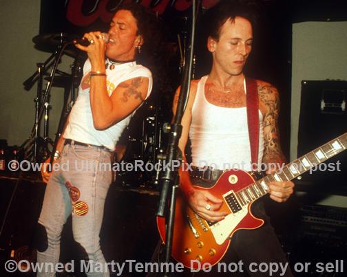 Photos of Stephen Pearcy of Ratt and Tracii Guns of L.A. Guns Onstage in 1991 in Hollywood, California by Marty Temme