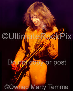 Photo of Peter Frampton playing a Les Paul in concert in 1975 by Marty Temme