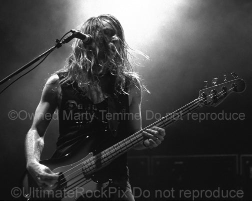 Black and white photo of Jeff Pilson of Dokken in concert in 1995 by Marty Temme