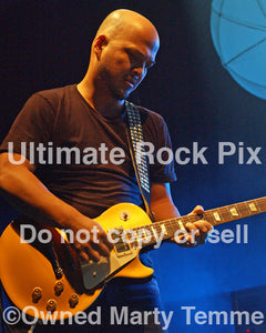 Photo of guitar player Joey Santiago of The Pixies in concert by Marty Temme