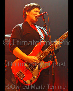 Photo of bass player Kim Deal of The Pixies in concert by Marty Temme