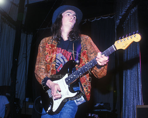 Photo of Mike McCready of Pearl Jam playing his black Stratocaster in 1991 by Marty Temme