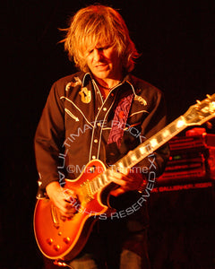 Photo of guitarist C.C. DeVille playing a Gibson Les Paul in concert in 2006