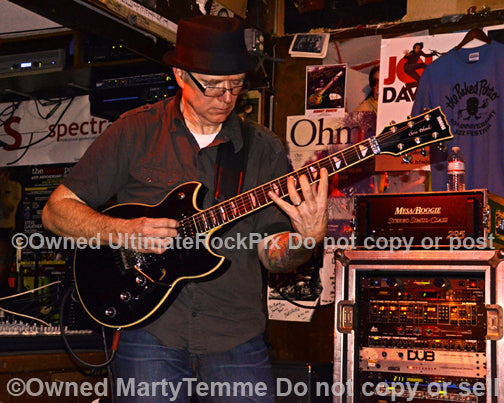 Photo of guitarist Chris Poland of Ohm in concert in 2012 by Marty Temme