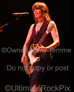 Photo of Chrissie Hynde of The Pretenders playing guitar in concert in 2007 by Marty Temme
