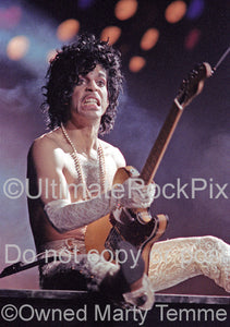 Photo of singer-songwriter and guitarist Prince performing in concert in 1984 by Marty Temme