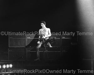 Photo of Freddie Mercury of Queen leaning on Brian May's Vox amplifiers in concert in 1980 by Marty Temme