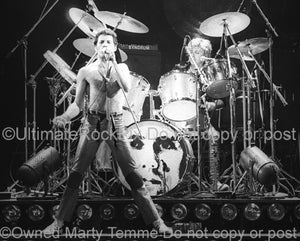 Photo of Freddie Mercury and Roger Taylor of Queen onstage in 1980 by Marty Temme