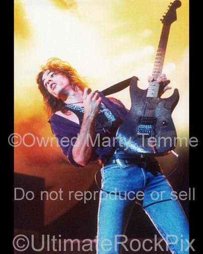Photo of guitarist Warren DeMartini of Ratt playing onstage in 1989 in Los Angeles, California by Marty Temme