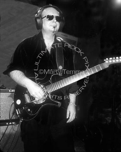 Black and white photo of Reeves Gabrels playing a Parker Fly guitar in concert by Marty Temme