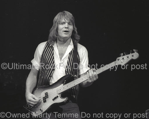 Photo of Bruce Hall of REO Speedwagon in concert in 1981 by Marty Temme