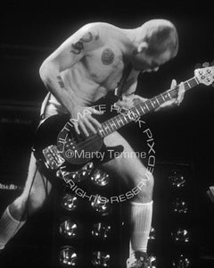Black and white photo of Flea of The Red Hot Chili Peppers in concert in 1992 by Marty Temme