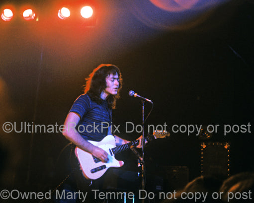 Photo of guitarist Rory Gallagher playing his Telecaster in concert in 1973 by Marty Temme