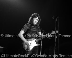 Black and white photo of Rory Gallagher playing his Stratocaster in 1973 by Marty Temme