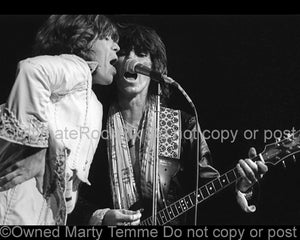 Photo of Mick Jagger and Keith Richards of The Rolling Stones in concert in 1975 by Marty Temme