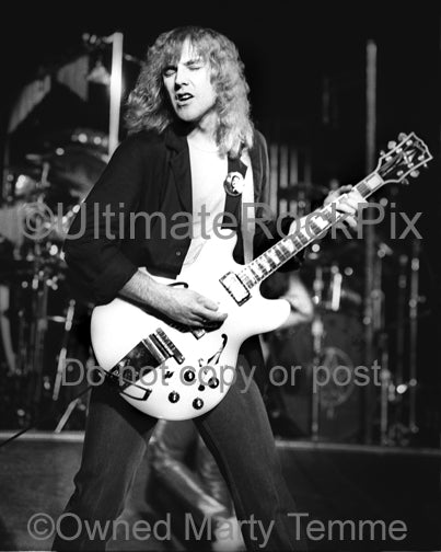 Black and white photo of Alex Lifeson in concert in 1980