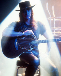 Photo of Richie Sambora of Bon Jovi with an Ovation guitar in 1991 by Marty Temme