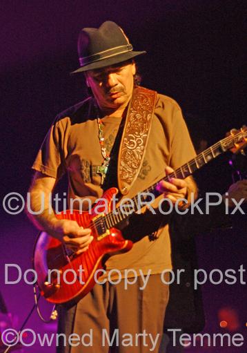 Photo of Carlos Santana in concert by Marty Temme