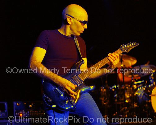 Photo of guitarist Joe Satriani in concert by Marty Temme