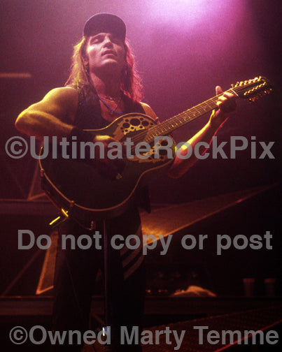 Photo of Matthias Jabs of Scorpions playing acoustic guitar in concert in 1991 by Marty Temme